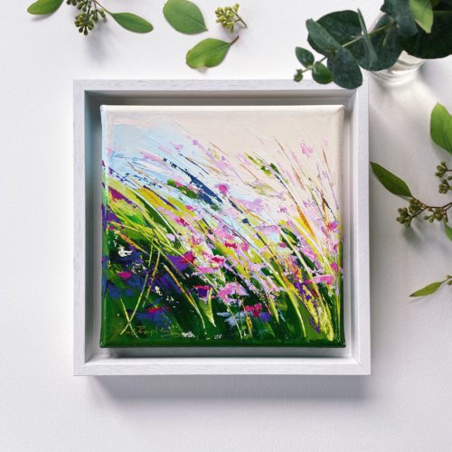 Floral oil painting on canvas, set in white wood frame, wild meadow flowers, pinks and greens, swaying in the summer breeze