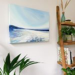 A Soulful Whisper - lifestyle image in home setting showing to show deep-edged canvas detail. Clear blue sky, the palest sandy beach stretching into the distance