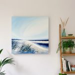 Wild and Windswept - lifestyle image in home setting to show deep-edged canvas. Clear blue sky, the palest sandy beach stretching into the distance, with tidal pools in view
